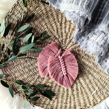 Load image into Gallery viewer, The Feather Girls macramé earrings in colour Vintage Rose, green eucalyptus leaves on the left side of the picture.