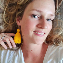 Load image into Gallery viewer, A model wearing macramé tassel earrings Pillow Talk in a shade Sunshine.