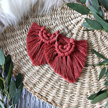 Load image into Gallery viewer, Rust coloured Boho Babe macramé earrings, eucalyptus leaves on the edges of the picture.
