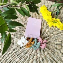 Load image into Gallery viewer, A set of macramé Wineglass Charms in shade Garden Party, yellow flowers on the right side, green leaves on the left side on the picture.
