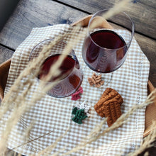 Load image into Gallery viewer, A set of macramé Wineglass Charms in a shade Sweater Weather, red wine in two glasses and a few bisquits on a tray.
