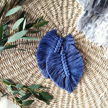 Load image into Gallery viewer, The Feather Girls macramé earrings in colour Jeans, green eucalyptus leaves on the left side of the picture.
