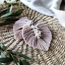 Load image into Gallery viewer, Uptown Pearl macramé earrings in colour Dusty Pink, green eucalyptus leaves on the left side of the picture.
