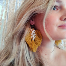 Load image into Gallery viewer, Model wearing Uptown Pearl macramé earrings in colour Ocra.
